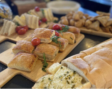 A platter of various appetizers and bread.