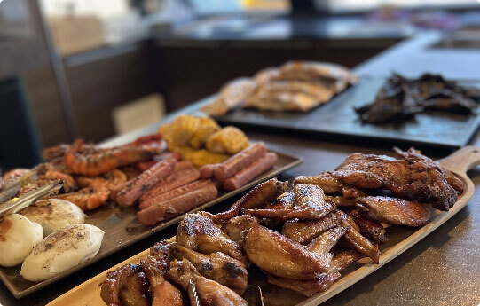 A buffet with a variety of grilled meat and seafood.