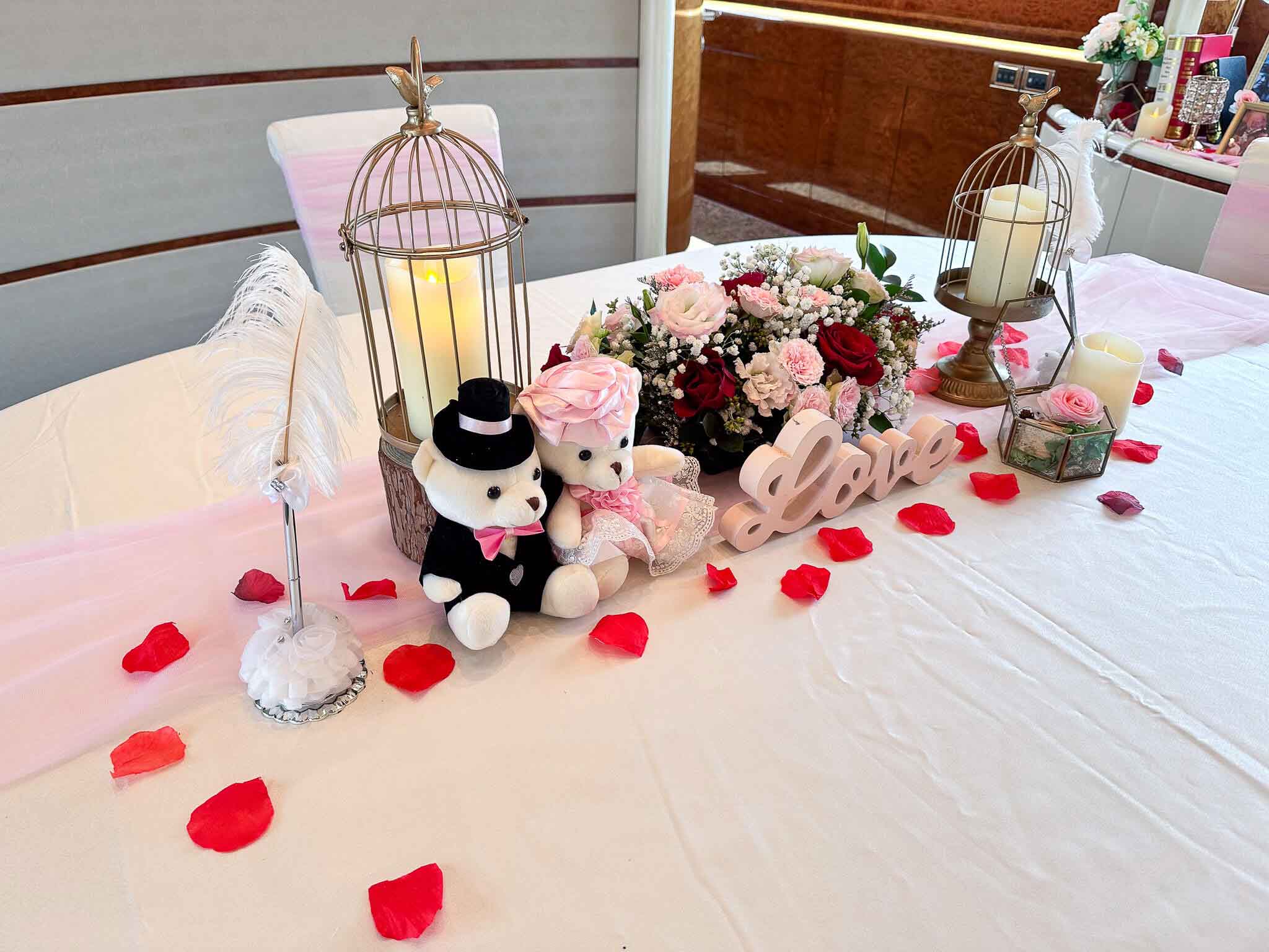 A table decorated with flowers, candles, and teddy bears.