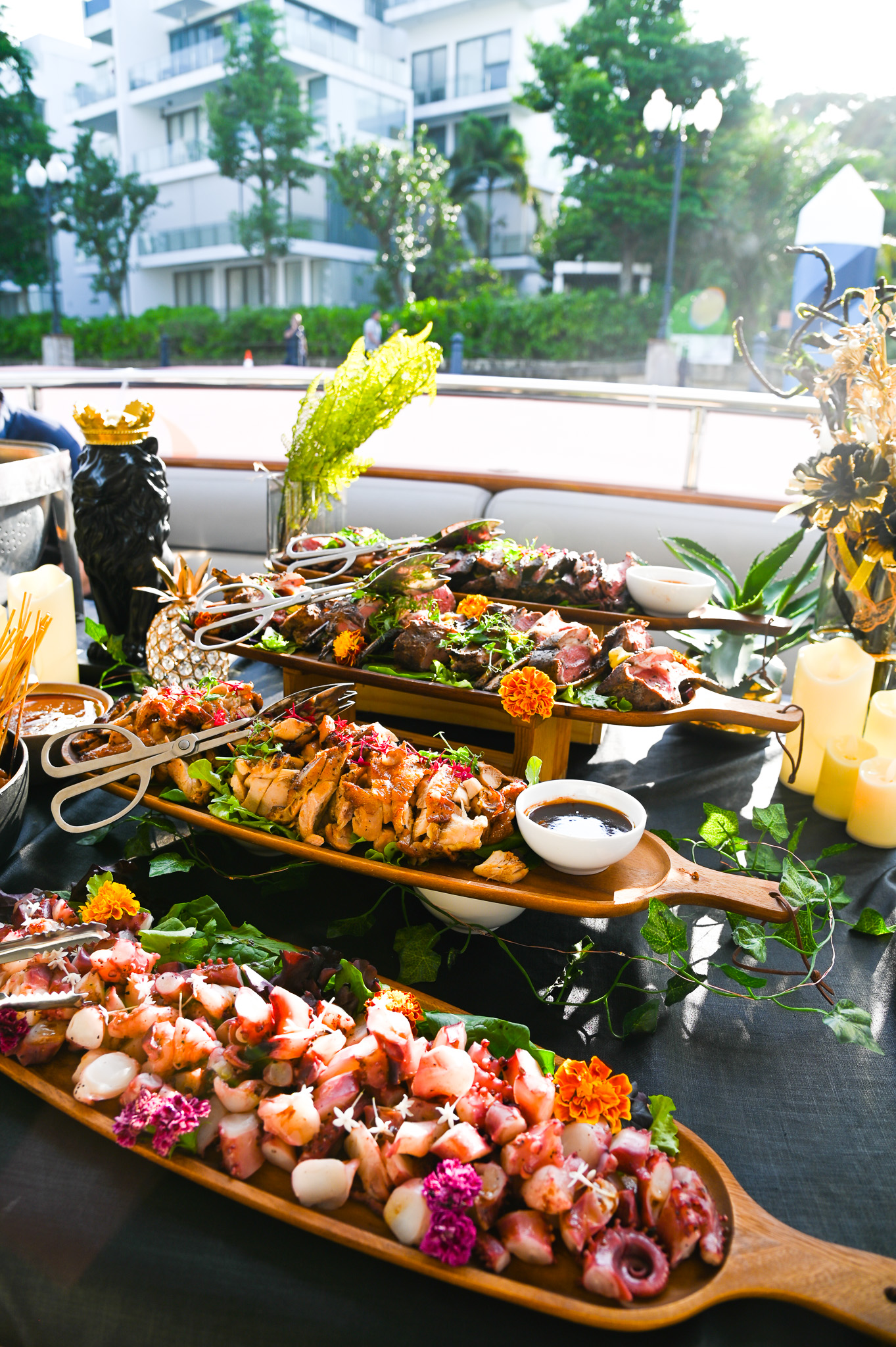 A luxurious buffet with octopus salad, sliced steak, and chicken.