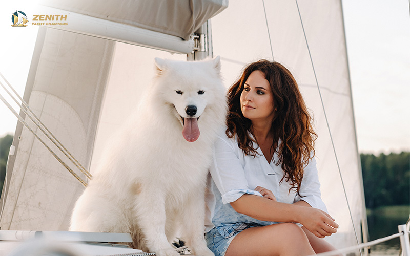 owner and her dog relaxing on a yacht
