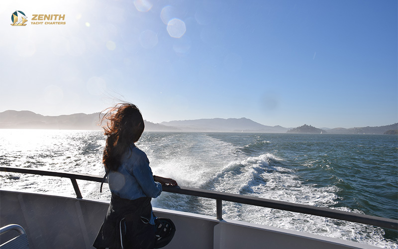 woman looking out the sea from a yacht 