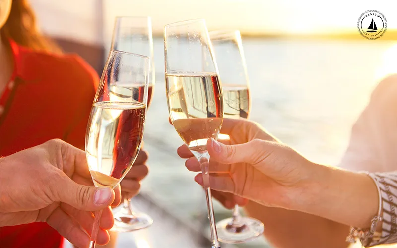 Woman-holding-champagne-glass-on-a-yacht-sailing-in-the-ocean