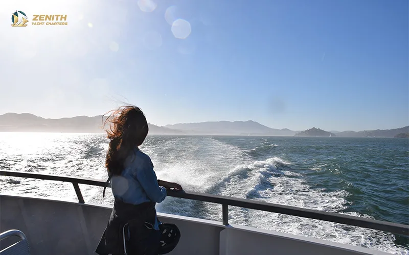 woman-looking-out-the-sea-from-a-yacht