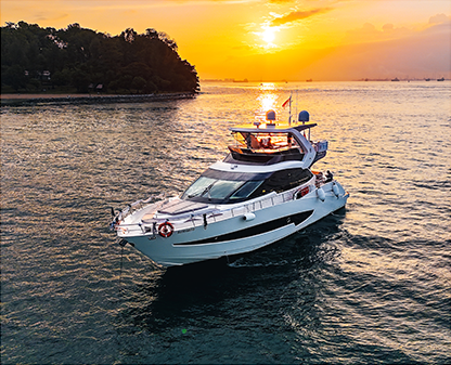 Luxury yacht sailing on the ocean during a golden sunset