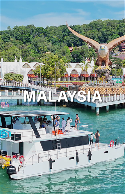 Yacht in Langkawi, Malaysia with a large eagle statue in the background